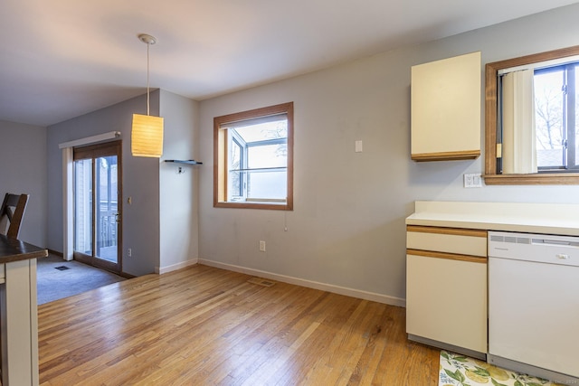 kitchen with dishwasher, decorative light fixtures, and light wood-type flooring