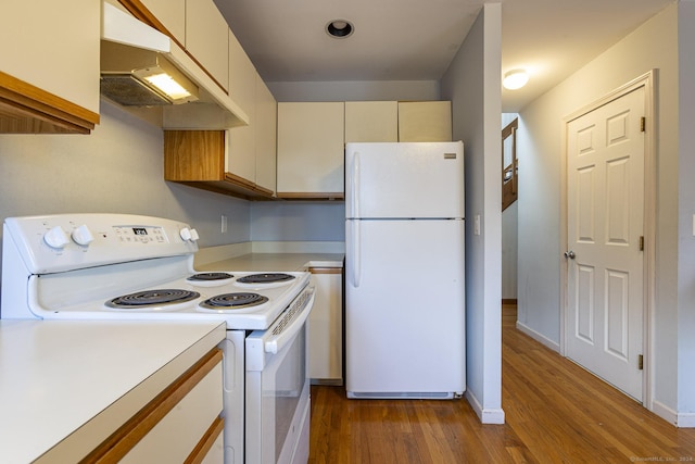 kitchen with cream cabinets, white appliances, and light hardwood / wood-style flooring