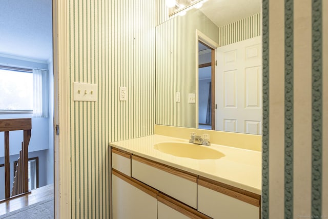 bathroom featuring vanity and ornamental molding