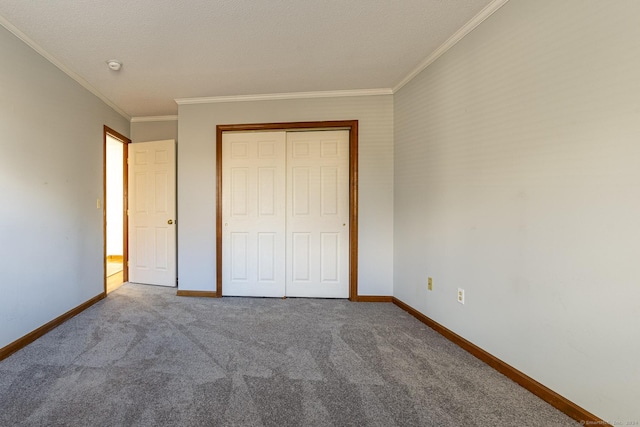 unfurnished bedroom with carpet flooring, a closet, and crown molding