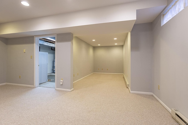 basement with a baseboard radiator and light colored carpet