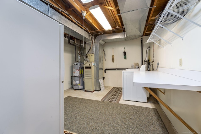 basement with washer and clothes dryer and gas water heater