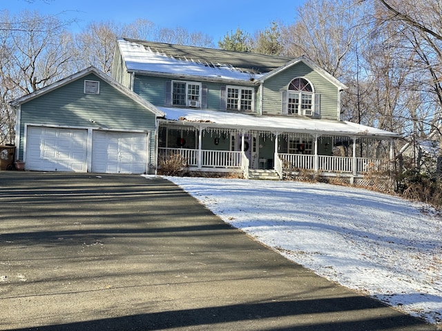 view of front facade with covered porch and a garage