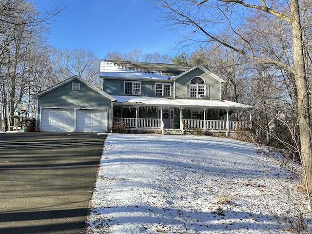 view of front of property with an outbuilding, covered porch, and a garage