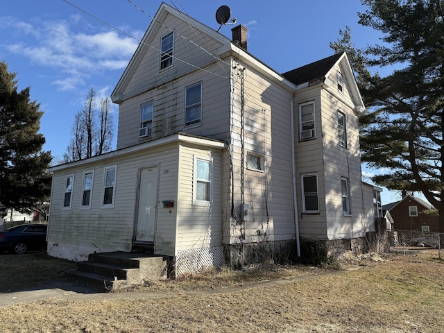 rear view of property with cooling unit