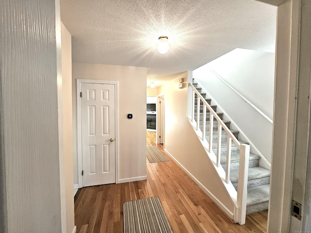 corridor featuring wood-type flooring