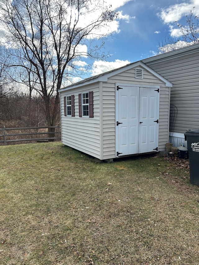 view of outdoor structure featuring a lawn