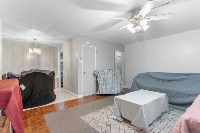 living room featuring ceiling fan with notable chandelier and light parquet floors