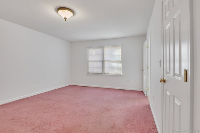 spare room with light colored carpet