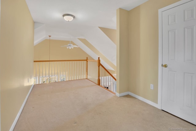 additional living space featuring ceiling fan, carpet floors, and vaulted ceiling