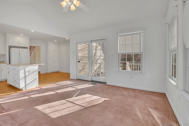 unfurnished living room featuring ceiling fan, light carpet, and high vaulted ceiling