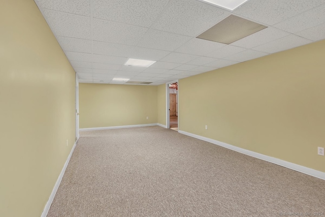 basement featuring carpet flooring and a drop ceiling