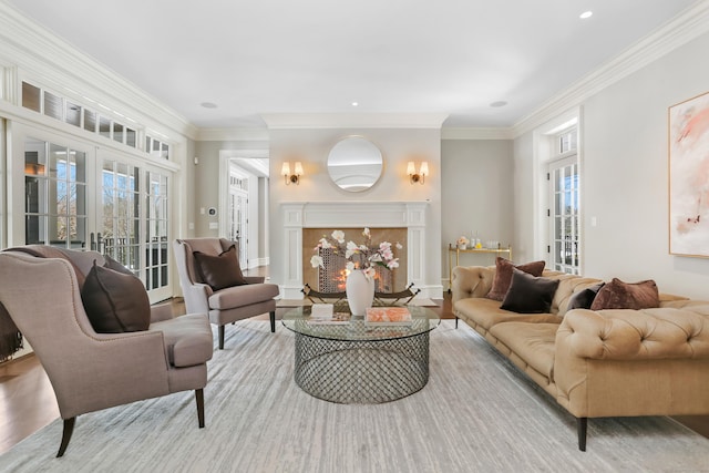 living room featuring plenty of natural light, ornamental molding, and light hardwood / wood-style floors