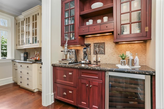 bar with wine cooler, dark hardwood / wood-style floors, dark stone counters, and decorative backsplash