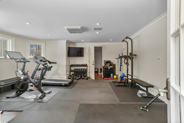 workout area featuring crown molding