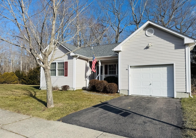 view of front facade with covered porch, a garage, and a front lawn