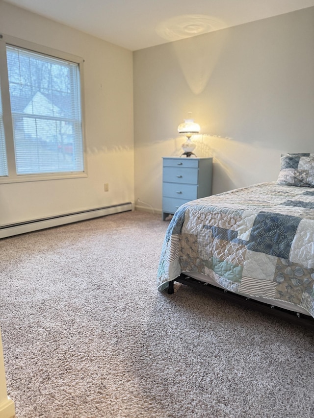 carpeted bedroom featuring baseboard heating