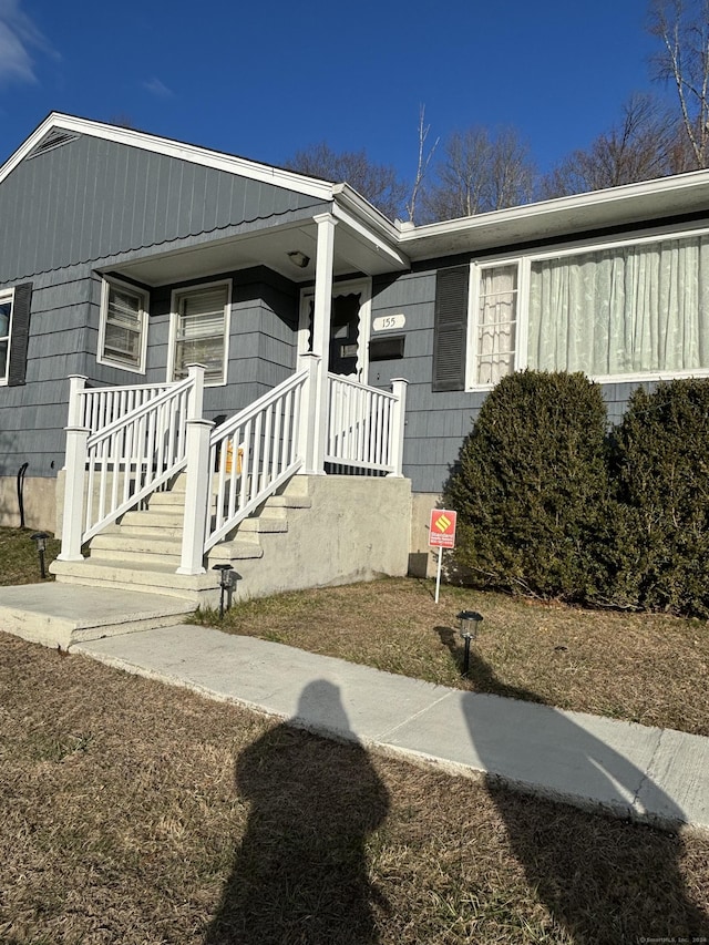 view of exterior entry with covered porch