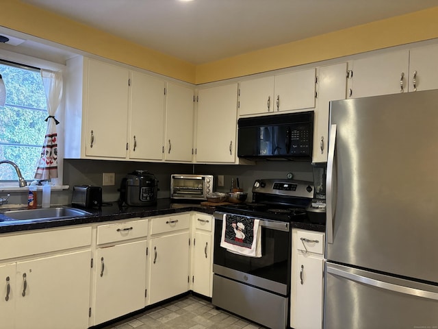 kitchen with white cabinetry, sink, and stainless steel appliances