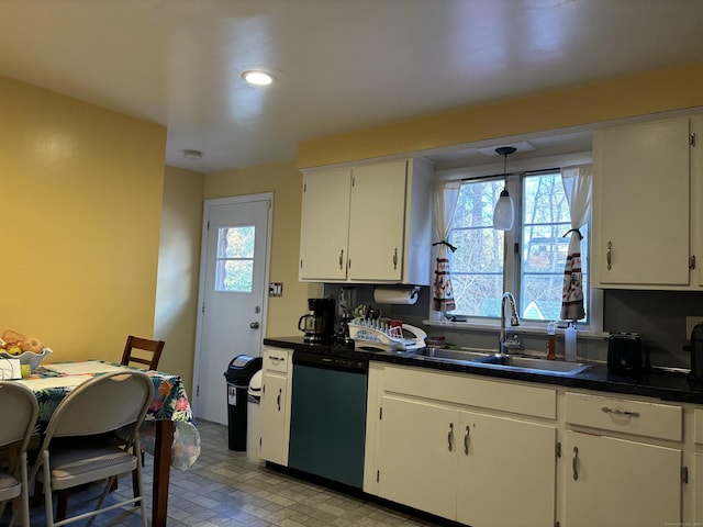 kitchen featuring dishwashing machine, pendant lighting, white cabinets, and sink