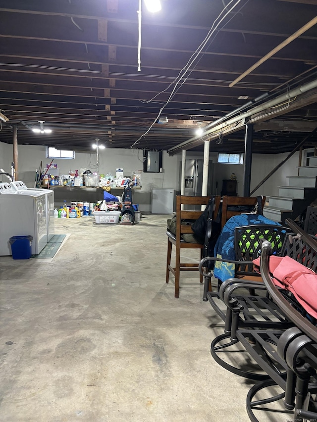 garage featuring independent washer and dryer and electric panel