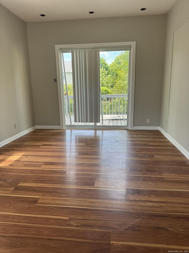 empty room with dark wood-type flooring