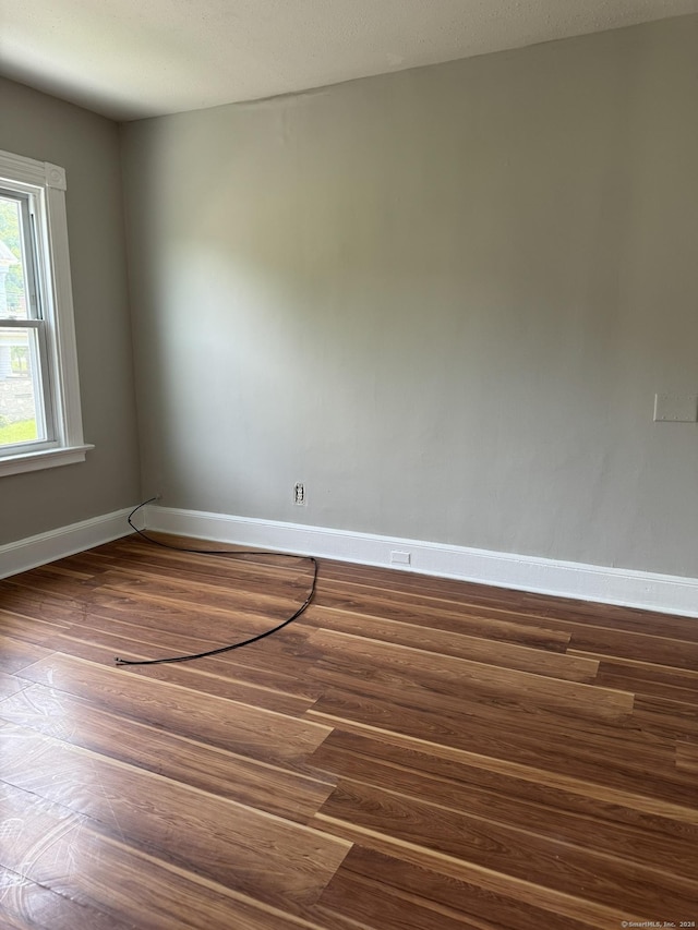 empty room with dark hardwood / wood-style floors