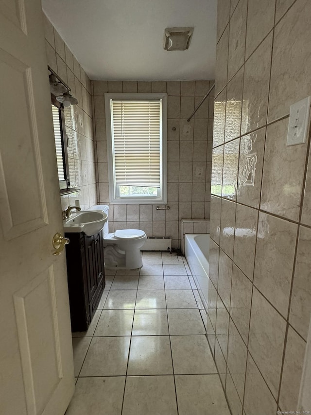 bathroom featuring tile patterned floors, vanity, a baseboard heating unit, tile walls, and toilet