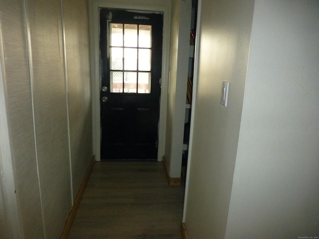 hallway with hardwood / wood-style floors