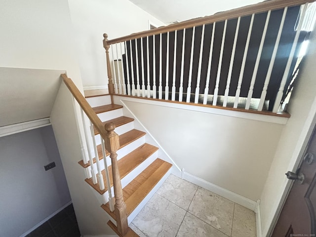 stairway with tile patterned floors