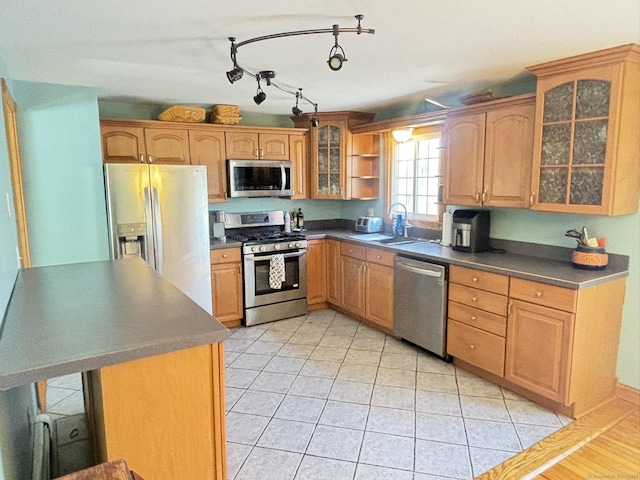 kitchen featuring sink, light tile patterned floors, and appliances with stainless steel finishes