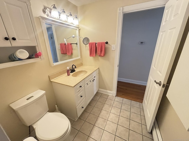 bathroom with tile patterned flooring, vanity, and toilet