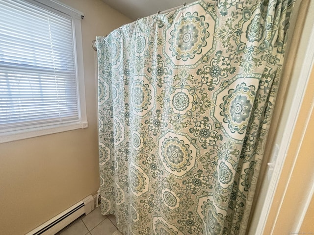 bathroom featuring tile patterned flooring and a baseboard heating unit