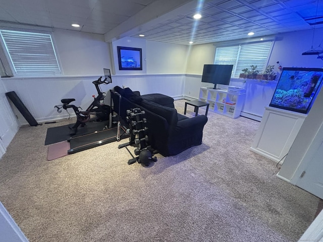 exercise area with carpet floors and a baseboard heating unit