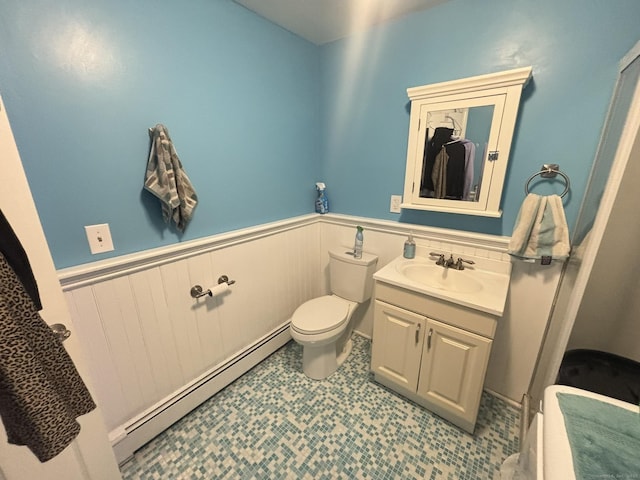 bathroom with vanity, toilet, and baseboard heating