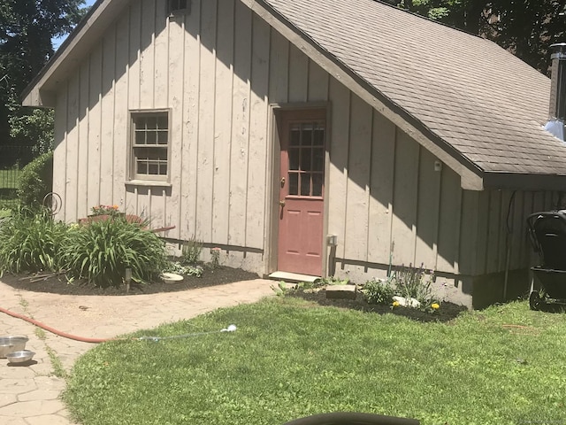 view of outbuilding featuring a lawn