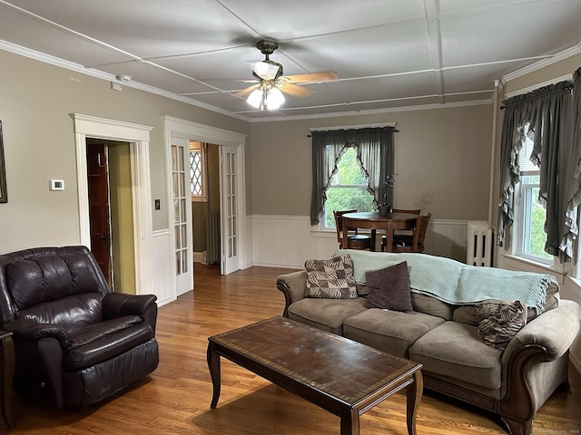 living room with ornamental molding, radiator, hardwood / wood-style floors, and ceiling fan