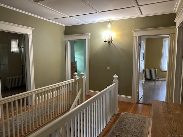 corridor featuring radiator and hardwood / wood-style flooring