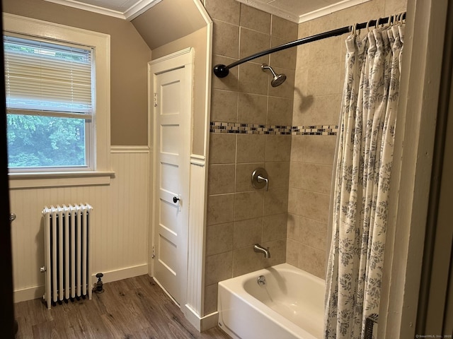 bathroom featuring hardwood / wood-style flooring, ornamental molding, radiator heating unit, and shower / bath combination with curtain