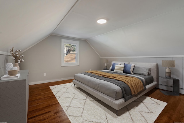 bedroom featuring vaulted ceiling and dark wood-type flooring