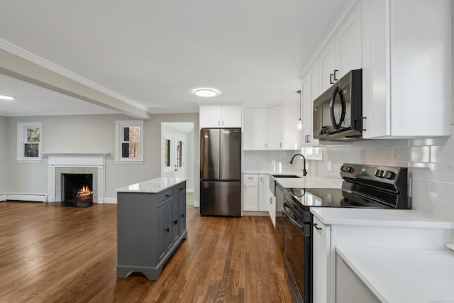 kitchen featuring gray cabinets, white cabinetry, and black appliances