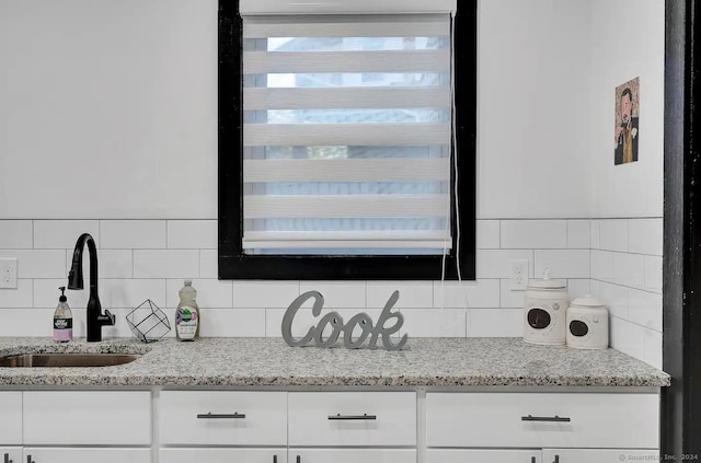 details featuring decorative backsplash and sink