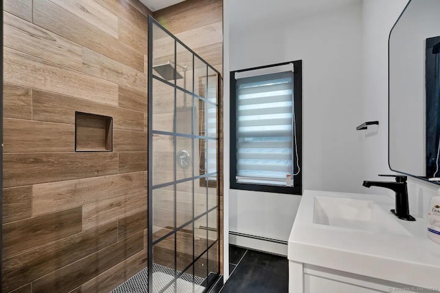 bathroom featuring baseboard heating, wooden walls, vanity, and tiled shower