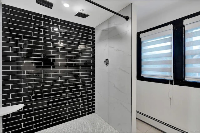 bathroom with tiled shower and a baseboard heating unit