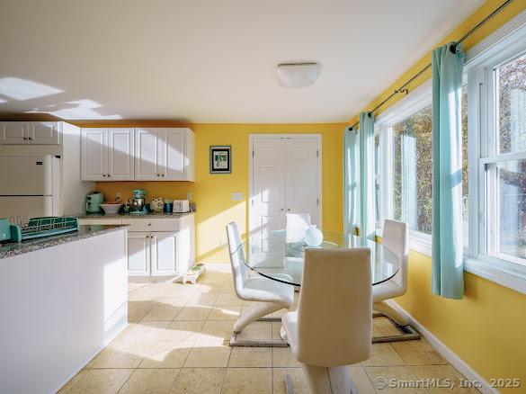 dining space featuring light tile patterned floors