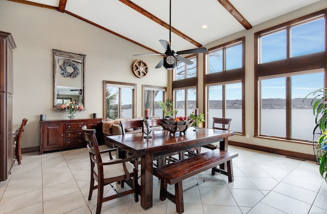 dining space featuring beamed ceiling, ceiling fan, a water view, and high vaulted ceiling