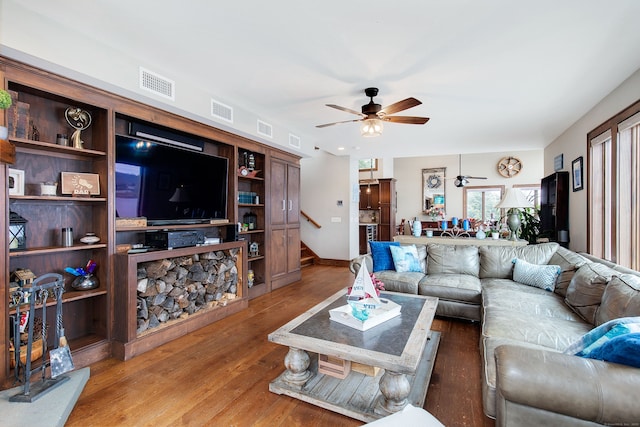 living room featuring hardwood / wood-style floors and ceiling fan