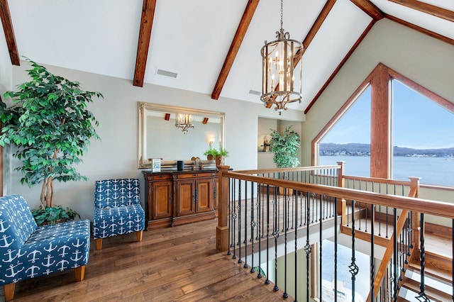 interior space featuring high vaulted ceiling, an inviting chandelier, a water view, dark hardwood / wood-style floors, and beam ceiling