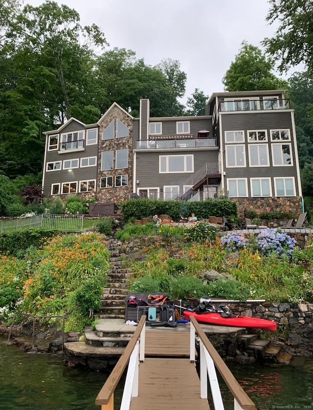 back of house featuring a water view