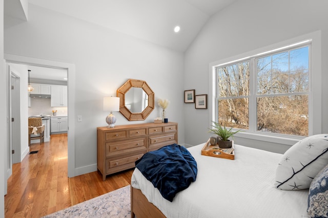 bedroom with light hardwood / wood-style floors and vaulted ceiling